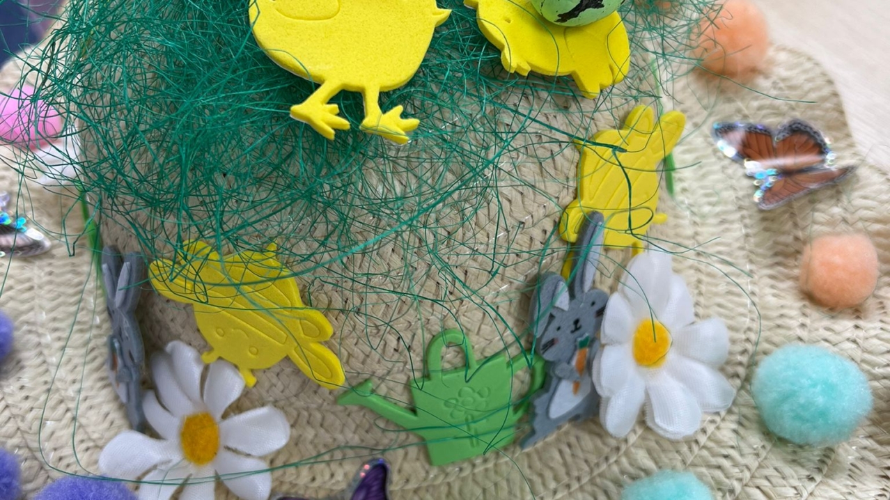 An Easter bonnet with a messy green birds nest propped on top.
