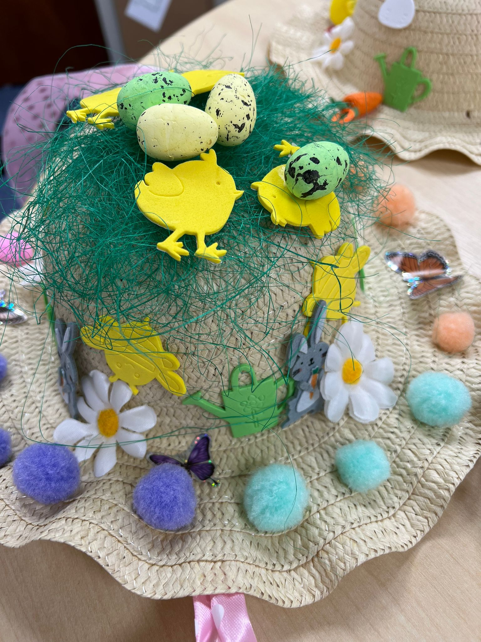 An Easter bonnet with a messy green birds nest propped on top.
